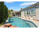 Backyard features a sparkling pool with mature landscaping, a covered patio, and a relaxing outdoor seating area at 10579 Garden Rose Dr, Las Vegas, NV 89135