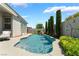 Beautiful pool area with lush landscaping provides privacy for outdoor enjoyment in this stunning backyard at 10579 Garden Rose Dr, Las Vegas, NV 89135