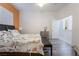 Well lit bedroom with wood-look floors and a seating area at 10579 Garden Rose Dr, Las Vegas, NV 89135