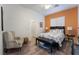 Comfortable bedroom with wood-look floors, a chair, and lots of natural light at 10579 Garden Rose Dr, Las Vegas, NV 89135