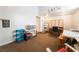 Multi-purpose bonus room with a craft area, desk, and 'Laugh' sign, offering space for hobbies and activities at 10579 Garden Rose Dr, Las Vegas, NV 89135