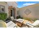 Charming courtyard space with a decorative wall, comfortable seating, and access to the main entrance at 10579 Garden Rose Dr, Las Vegas, NV 89135