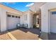 Inviting courtyard area with seating, an arched entrance, and convenient garage access at 10579 Garden Rose Dr, Las Vegas, NV 89135