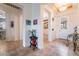 Welcoming entryway featuring tile flooring, decorative artwork, and a view to adjacent living spaces at 10579 Garden Rose Dr, Las Vegas, NV 89135