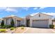 Beautiful exterior view of a single-story home with a two-car garage and well-maintained landscaping at 10579 Garden Rose Dr, Las Vegas, NV 89135