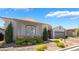 Inviting single-story home featuring stone accents, lush shrubs, and a convenient two-car garage at 10579 Garden Rose Dr, Las Vegas, NV 89135