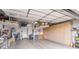 Epoxy-coated garage featuring overhead storage racks and built-in cabinets for maximum organization and functionality at 10579 Garden Rose Dr, Las Vegas, NV 89135