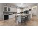 The kitchen has white cabinets, black appliances, and a large center island with seating at 10579 Garden Rose Dr, Las Vegas, NV 89135