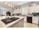 Spacious kitchen with white cabinets, center island with a gas cooktop, and modern appliances at 10579 Garden Rose Dr, Las Vegas, NV 89135