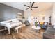 Bright living room featuring hardwood floors, a white piano, and comfortable seating at 10579 Garden Rose Dr, Las Vegas, NV 89135