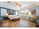 Main bedroom features hardwood floors, neutral walls, ceiling fan, and natural light at 10579 Garden Rose Dr, Las Vegas, NV 89135