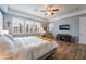 A cozy main bedroom with a decorative ceiling fan, plantation shutters and wood-look floors at 10579 Garden Rose Dr, Las Vegas, NV 89135