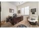 Bright home office with wood floors, a large desk, comfortable seating, and plenty of natural light at 10579 Garden Rose Dr, Las Vegas, NV 89135