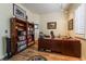 Spacious home office featuring built-in bookshelves, a large desk, and a comfortable chair for productivity at 10579 Garden Rose Dr, Las Vegas, NV 89135