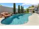Inviting backyard pool featuring a rock waterfall, lush landscaping, and mature trees creating a private oasis at 10579 Garden Rose Dr, Las Vegas, NV 89135