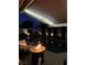 Stunning nighttime view of the pool area, featuring soft lighting, a fire pit, and elegant patio furniture at 10579 Garden Rose Dr, Las Vegas, NV 89135