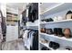 A walk-in closet with custom shelving and hanging racks for optimal storage at 10579 Garden Rose Dr, Las Vegas, NV 89135