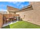 Cozy backyard patio featuring artificial grass and outdoor seating under a bright, sunny sky at 10636 Colter Bay Ct, Las Vegas, NV 89129