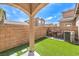 Private backyard with artificial grass and seating provides a low-maintenance outdoor retreat at 10636 Colter Bay Ct, Las Vegas, NV 89129
