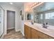 Bathroom with dual sinks, mirrors, and a glass-enclosed shower for a spa-like experience at 10636 Colter Bay Ct, Las Vegas, NV 89129