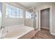 Relaxing bathroom with a soaking tub and separate glass-enclosed shower at 10636 Colter Bay Ct, Las Vegas, NV 89129