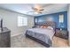 Comfortable main bedroom boasts a blue accent wall, ceiling fan, and ample natural light at 10636 Colter Bay Ct, Las Vegas, NV 89129