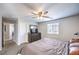 Neutral bedroom with a ceiling fan, carpet floors, and dresser, creating a serene retreat at 10636 Colter Bay Ct, Las Vegas, NV 89129