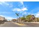 Gated community entrance with manicured landscaping and clear blue skies at 10636 Colter Bay Ct, Las Vegas, NV 89129