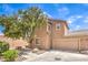 Two-story home showcasing desert landscaping, a two-car garage, and a mature shade tree at 10636 Colter Bay Ct, Las Vegas, NV 89129
