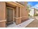 Front entrance showcasing a solid wood door and manicured desert landscaping at 10636 Colter Bay Ct, Las Vegas, NV 89129