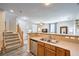 Open kitchen view to the living room and staircase with stainless steel appliances and wood cabinets at 10636 Colter Bay Ct, Las Vegas, NV 89129