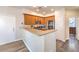 Efficient kitchen with wood cabinets, stainless steel appliances, and a breakfast bar at 10636 Colter Bay Ct, Las Vegas, NV 89129