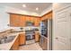 Practical kitchen with stainless steel appliances, wood cabinetry, and a laminate countertop at 10636 Colter Bay Ct, Las Vegas, NV 89129
