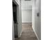 Hallway featuring wood-look flooring, neutral paint, and access to bathroom and another room at 1111 Sixshooter Ave, Pahrump, NV 89048