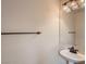 Bathroom with a white pedestal sink, bronze fixtures, and a decorative vanity light at 1115 Aldenwood Ave, Las Vegas, NV 89123