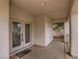 Welcoming covered porch area features double doors with decorative glass inserts and neutral finishes at 1115 Aldenwood Ave, Las Vegas, NV 89123