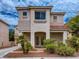 Inviting two-story home with desert landscaping and covered porch features an elegant double-door entryway at 1115 Aldenwood Ave, Las Vegas, NV 89123