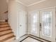 Bright foyer showcases tiled floors, decorative glass double doors, and staircase at 1115 Aldenwood Ave, Las Vegas, NV 89123