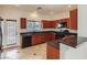 Traditional kitchen showcases wood cabinetry, black appliances, tile floors and backyard views at 1115 Aldenwood Ave, Las Vegas, NV 89123