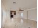 Open living space featuring light tile floors, neutral walls, ceiling fans, and window shutters at 1115 Aldenwood Ave, Las Vegas, NV 89123