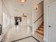 Open living space featuring light tile floors, neutral walls, ceiling fans, and window shutters at 1115 Aldenwood Ave, Las Vegas, NV 89123