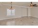 Open living space featuring light tile floors, neutral walls, ceiling fans, and window shutters at 1115 Aldenwood Ave, Las Vegas, NV 89123