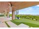 Expansive backyard with a covered patio, spiral staircase, putting green, and stunning views at 11152 San Terrazo Pl, Las Vegas, NV 89141