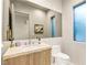Modern bathroom featuring marble countertops, sleek fixtures, and a large mirror at 11152 San Terrazo Pl, Las Vegas, NV 89141
