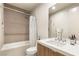 Bright bathroom featuring a tub with shower, single sink vanity, and neutral tile at 11152 San Terrazo Pl, Las Vegas, NV 89141