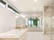 A well-lit bathroom featuring a soaking tub, double sinks and a walk-in shower at 11152 San Terrazo Pl, Las Vegas, NV 89141