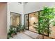 Private courtyard with lush landscaping and a glimpse of a bedroom through sliding glass doors at 11152 San Terrazo Pl, Las Vegas, NV 89141