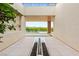 Grand entrance with modern water feature and view of the sparkling pool and lush landscaping at 11152 San Terrazo Pl, Las Vegas, NV 89141
