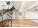 Spacious entryway featuring hardwood floors, modern floating staircase, and lots of natural light at 11152 San Terrazo Pl, Las Vegas, NV 89141