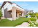 A modern home's backyard with a pool, putting green, and spiral staircase at 11152 San Terrazo Pl, Las Vegas, NV 89141